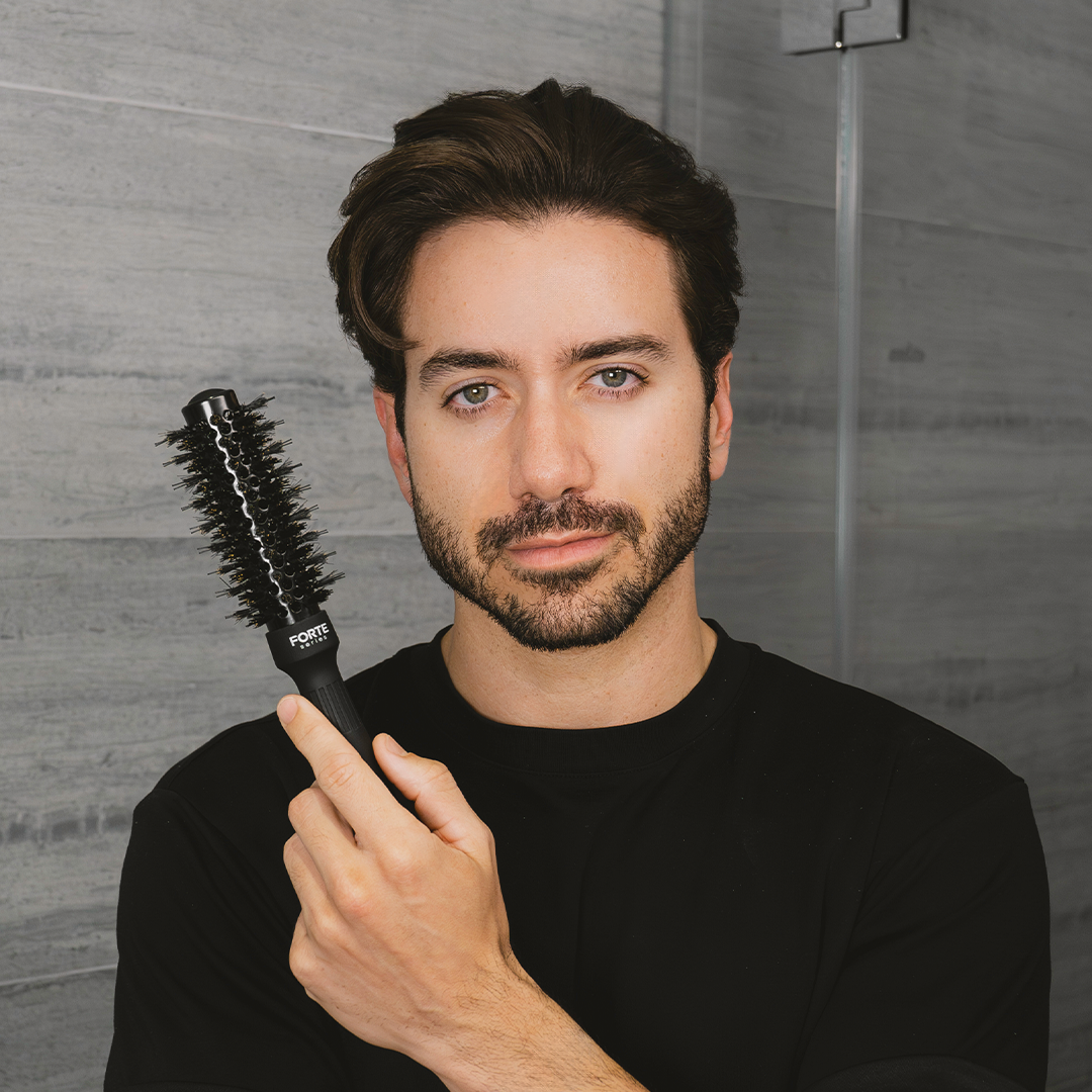 A single green leaf against a white background.