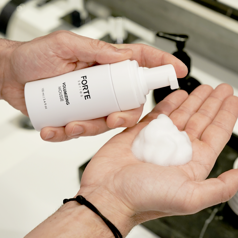 A single green leaf against a white background.