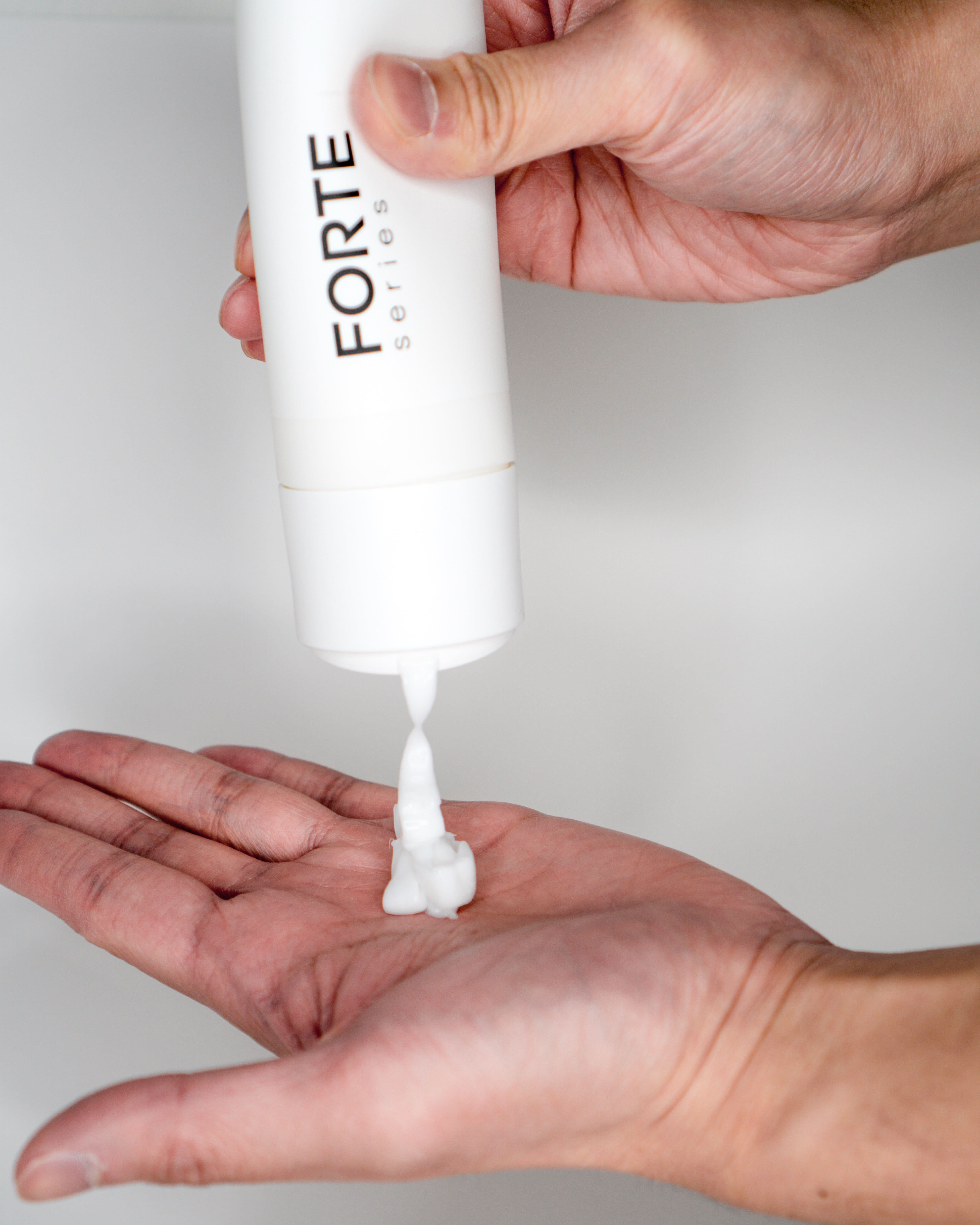 A single green leaf against a white background.