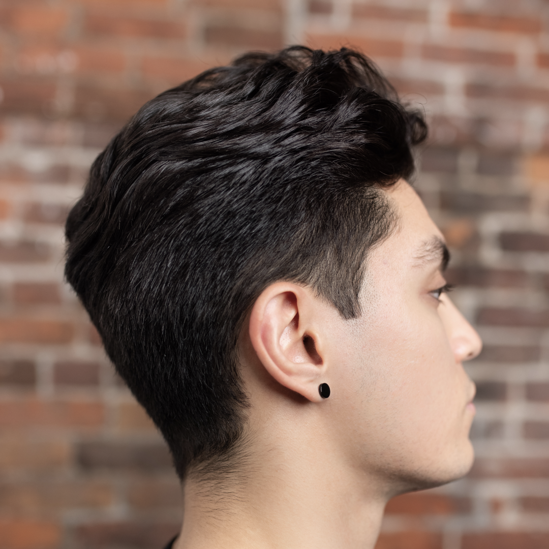 A single green leaf against a white background.